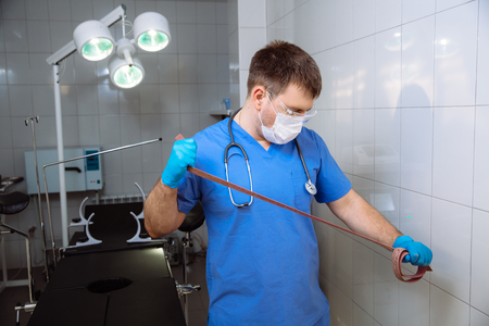 Surgeon holding medical instruments in hands. Concept of healthyの写真素材