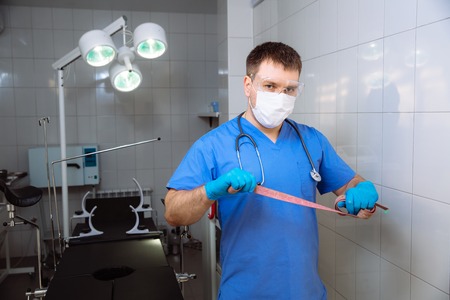 Surgeon holding medical instruments in hands. Concept of healthyの写真素材