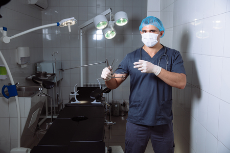 Surgeon holding medical instruments in hands. Concept of healthyの写真素材