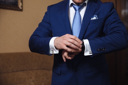 Businessman checking time on his wristwatch. men's hand with a watchの写真素材