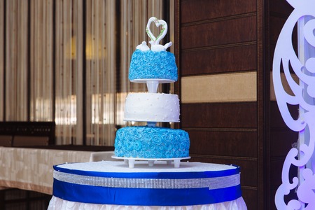 Multilevel wedding cake. Sweet cake in white and blue colourの写真素材