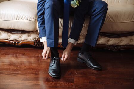 Business man dressing up with classic, elegant shoes. Groom wearing shoes on wedding dayの写真素材