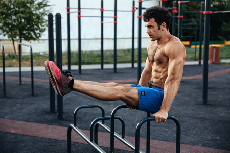 Muscular man at crossfit ground doing push ups as part of training. Sport conceptの写真素材