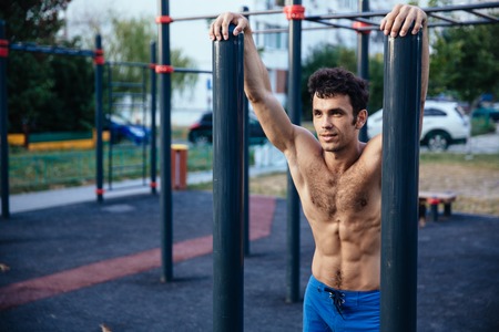 Muscular man at crossfit ground doing push ups as part of training. Sport conceptの写真素材