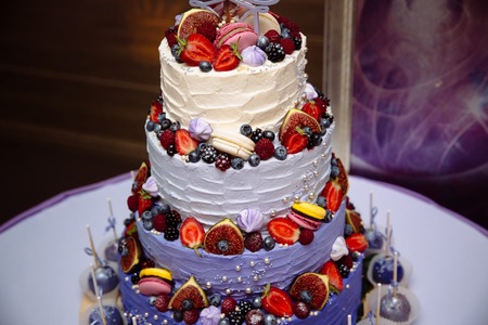 Sweets multilevel wedding cake decorated with fruits.の写真素材