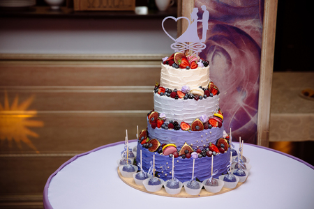 Sweets multilevel wedding cake decorated with fruits.の写真素材