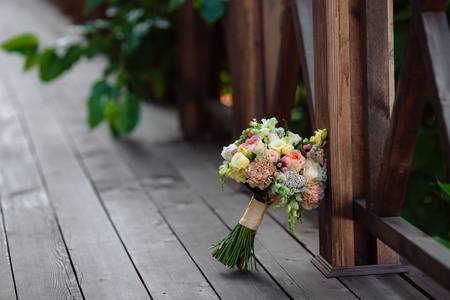 Wedding bouquet. Bride's flowers on wood backgroundの写真素材