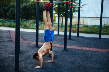 Muscular man at crossfit ground doing push ups as part of training. Sport conceptの写真素材