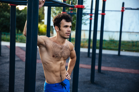 Muscular man at crossfit ground doing push ups as part of training. Sport conceptの写真素材
