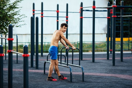 Muscular man at crossfit ground doing push ups as part of training. Sport conceptの写真素材