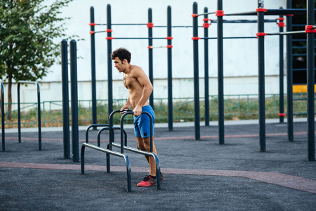 Muscular man at crossfit ground doing push ups as part of training. Sport conceptの写真素材