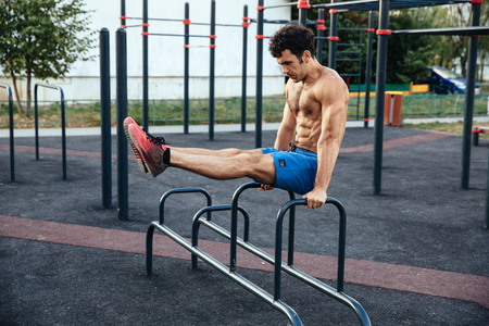 Muscular man at crossfit ground doing push ups as part of training. Sport conceptの写真素材