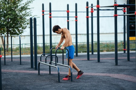 Muscular man at crossfit ground doing push ups as part of training. Sport conceptの写真素材