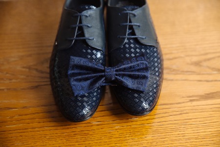 men's accessories, bowtie, shoes, strap on the tableの写真素材