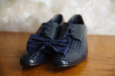 men's accessories, bowtie, shoes, strap on the tableの写真素材