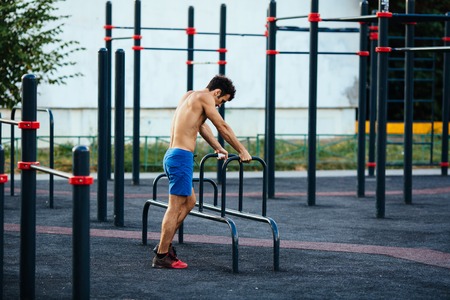 Muscular man at crossfit ground doing push ups as part of training. Sport conceptの写真素材