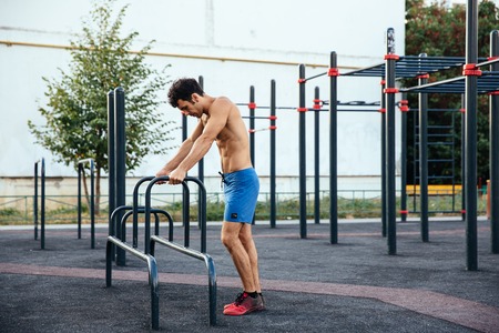 Muscular man at crossfit ground doing push ups as part of training. Sport conceptの写真素材