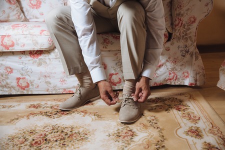 Business man dressing up with classic, elegant shoes. Groom wearing shoes on wedding dayの写真素材