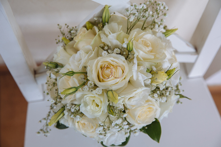 Gold rings on wedding bouquet of blue and white fresh flowersの写真素材