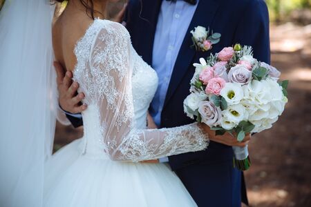 Wedding bouquet in marriage couple hands.の写真素材