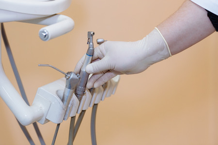 Dentist doctor hand holding medical tools in dental office. Concept healthyの写真素材