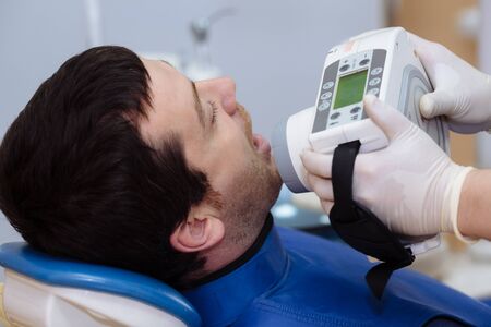 X-ray device in hands of dentist. Dentist equipment, medical instrument. Concept of healthy.の写真素材