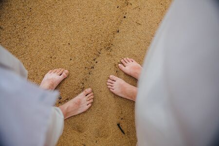 foot guy and girl in the sand Sea Beachの写真素材