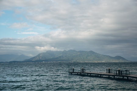 Beautiful landscape with bridge and view of ocean, perfect beach, big stones, trees, azure water. Background imageの写真素材