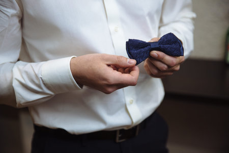 Man holding bow tie. Elegant gentleman clother.の写真素材