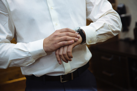 Businessman checking time on his wristwatch. mens hand with a watch.の写真素材