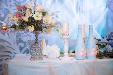 Wedding decorated table with candles and champagne in the tenderly light blue styleの写真素材