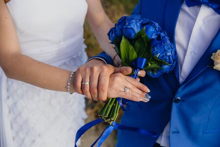 Closeup groom and bride are holding hands at wedding day ang show rings. Concept of love familyの写真素材