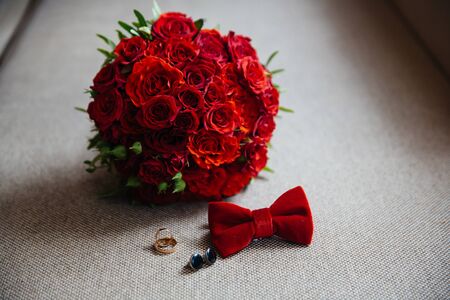 Wedding groom accessories, details of clothes, bow tie, cuff links, golden rings.の写真素材