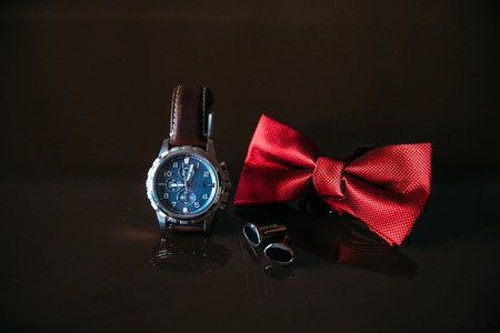 Wedding groom accessories, details of clothes, bow tie, cuff links, golden rings.の写真素材