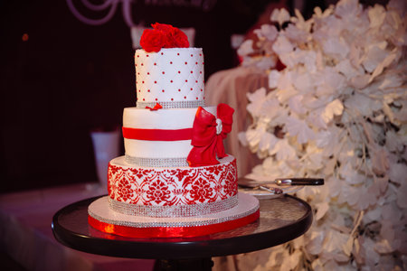 Big sweet multilevel wedding cake decorated with flowers. Concept of candy bar on party