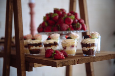 Candy bar. Table with sweets, buffet with cupcakes, candies, dessert.の写真素材