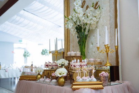 Candy bar. Table with sweets, buffet with cupcakes, candies, dessert.の写真素材