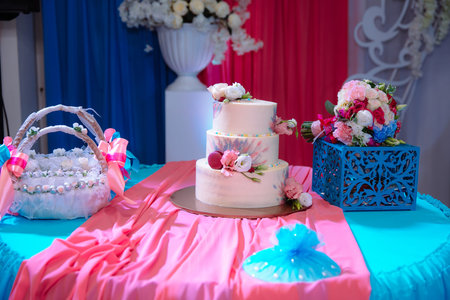 Big sweet multilevel wedding cake decorated with flowers. Concept of candy bar on party