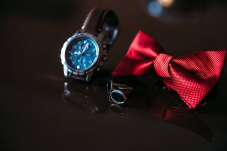 Wedding groom accessories, details of clothes, bow tie, cuff links, golden rings.の写真素材