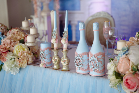Wedding decorated table with candles and champagne in the tenderly light blue styleの写真素材