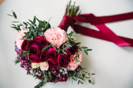 beautiful brides wedding bouquet with red roses on white background. Concept of floristicsの写真素材