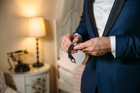Businessman checking time on his wristwatch. mens hand with a watch.の写真素材