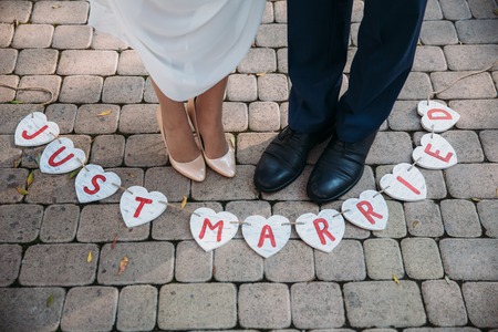 Beautiful wedding inscription just married. Close-up beauty placard. Bridal and groom accessories. Details for marriage, decoration for coupleの写真素材