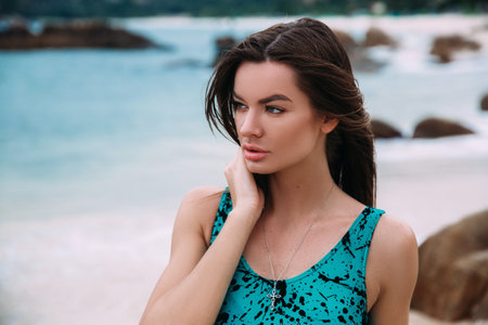 A close-up of the face of a young girl, rough features, beautiful lines of lips and eyes, the wind...