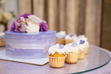 Candy bar and wedding cake. Table with sweets, buffet with cupcakes, candies, dessertの写真素材