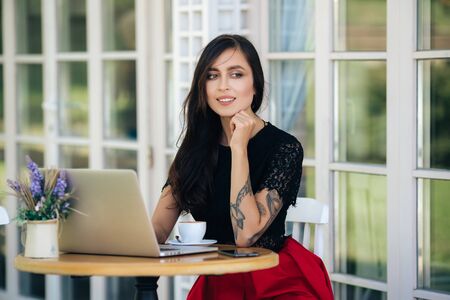 Beautiful girl businesswoman working on laptop in cafe, female freelancerの写真素材