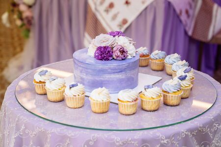 Candy bar. Table with sweets, buffet with cupcakes, candies, dessertの写真素材
