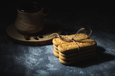 Coffee and cookies tied with a rope on an abstract backgroundの写真素材
