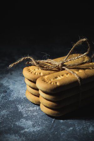 Biscuits tied with a rope on an abstract backgroundの写真素材