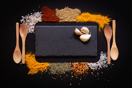 Set of Various spices on black stone table. Top view with copy space.